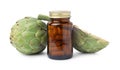 Fresh artichokes and bottle of pills isolated on white Royalty Free Stock Photo