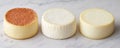 Fresh Artisan Cheese Rounds White and Brown on Marble Surface AI generated. Royalty Free Stock Photo