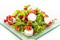 Fresh arugula salad with beetroot, goat cheese and walnuts on glass plate isolated on white background, product photography for re