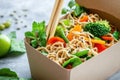 Fresh asian noodle box with vegetables featuring broccoli, carrots, and peppers Royalty Free Stock Photo