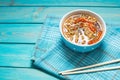 Fresh asian vegetable soup with noodles on blue wood background