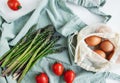 Fresh Asparagus and Brown Eggs on a Light Background With Cherry Tomatoes Royalty Free Stock Photo