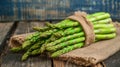 Fresh asparagus bunches wrapped in burlap on a wooden table,. Generated AI Royalty Free Stock Photo