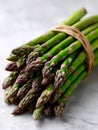 Fresh asparagus bundle on a light textured surface. Royalty Free Stock Photo