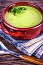 Fresh asparagus creamy soup and ingredients on a wooden table. Royalty Free Stock Photo