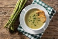 Fresh asparagus soup in bowl on wooden table Royalty Free Stock Photo