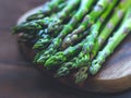 Fresh asparagus spears arranged on a wooden cutting board Royalty Free Stock Photo