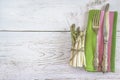 Fresh asparagus, vintage cutlery on the green napkin and rustic white paint wooden background Royalty Free Stock Photo