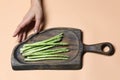 Fresh asparagus on a wooden cutting board on pink background Royalty Free Stock Photo