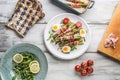 Fresh asparagus wrapped in bacon on a white plate with arugula Royalty Free Stock Photo