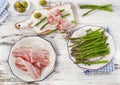 Fresh asparagus wrapped in bacon on a wooden table. Royalty Free Stock Photo