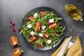 Fresh autumn salad with persimmon, arugula, cheese