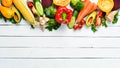 Fresh autumn vegetables on white wooden background.