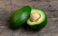 Fresh Avocado cut in half on wooden board background Royalty Free Stock Photo