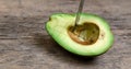 Fresh Avocado cut in half on wooden board with knife background Royalty Free Stock Photo
