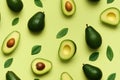 fresh avocado fruit with leaves on light green background. seamless pattern