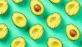 Fresh avocado halves arranged in a repeating pattern on a teal background Royalty Free Stock Photo