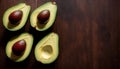 Fresh Avocado Halves on a Dark Wooden Surface, Copy Space