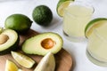 Fresh avocado, lime, drink and nacho chips lying on marble background. Recipe for Cinco de Mayo party Royalty Free Stock Photo