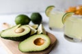 Fresh avocado, lime, drink and nacho chips lying on marble background. Recipe for Cinco de Mayo party Royalty Free Stock Photo