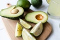 Fresh avocado, lime, drink and nacho chips lying on marble background. Recipe for Cinco de Mayo party Royalty Free Stock Photo