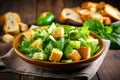 fresh avocado salad with crunchy croutons on wooden table