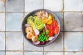 Fresh Avocado, shrimps salad with green pies, cherry tomatoes, herbs and olive oil, lemon dressing