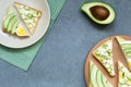 Fresh avocado toasts with different toppings. Healthy vegetarian breakfast with rye wholegrain sandwiches, top view Royalty Free Stock Photo