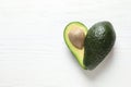 Fresh avocado on wooden background, top view with space for text. Heart-healthy