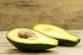 Fresh avocados on wooden background.