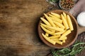 Fresh baby corn cobs and spices on wooden table, flat lay. Space for text Royalty Free Stock Photo