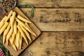 Fresh baby corn cobs and spices on wooden table, flat lay. Space for text Royalty Free Stock Photo