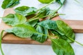 Fresh Baby Spinach Leaves on Wooden Board Royalty Free Stock Photo