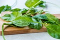 Fresh Baby Spinach Leaves on Wooden Board Royalty Free Stock Photo