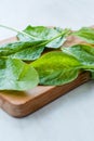 Fresh Baby Spinach Leaves on Wooden Board Royalty Free Stock Photo