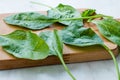 Fresh Baby Spinach Leaves on Wooden Board Royalty Free Stock Photo