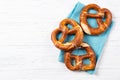 Fresh backed pretzels on a blue towel, beer snack, top view with copy space