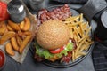 Fresh bacon burger and fries on table, above view Royalty Free Stock Photo