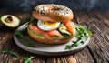 Fresh bagel with salmon, avocado, egg, rucola. Healthy and tasty breakfast