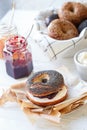 Fresh bagels with cream cheese and jam,close up, white background