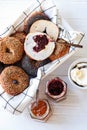 Fresh bagels with cream cheese and jam, top view