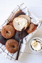 Fresh bagels with cream cheese and jam, top view, white background