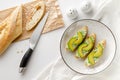 Fresh baguette with ricotta, spinach and avocado. Healthy snack concept.