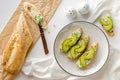 Fresh baguette with ricotta, spinach and avocado. Healthy snack concept.