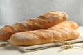 Fresh baguettes and spikes on beige table, closeup Royalty Free Stock Photo