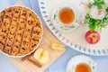 Fresh baked apple pie, cup of tea and flowers on a table Royalty Free Stock Photo