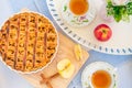 Fresh baked apple pie, cup of tea and flowers on a table Royalty Free Stock Photo