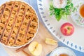 Fresh baked apple pie, cup of tea and flowers on a table Royalty Free Stock Photo