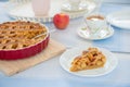 Fresh baked apple pie, cup of tea and flowers on a table Royalty Free Stock Photo