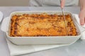 Fresh baked beef lasagna in baking dish close up on kitchen table. Royalty Free Stock Photo